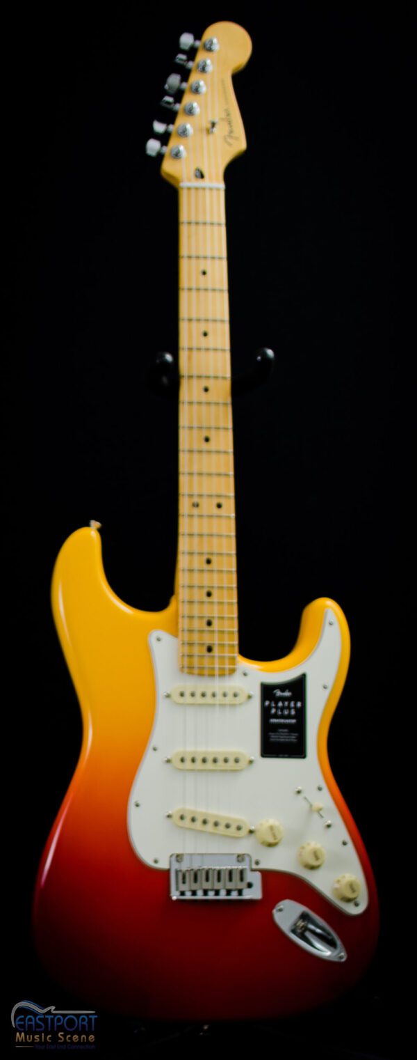 A yellow electric guitar with black strings.